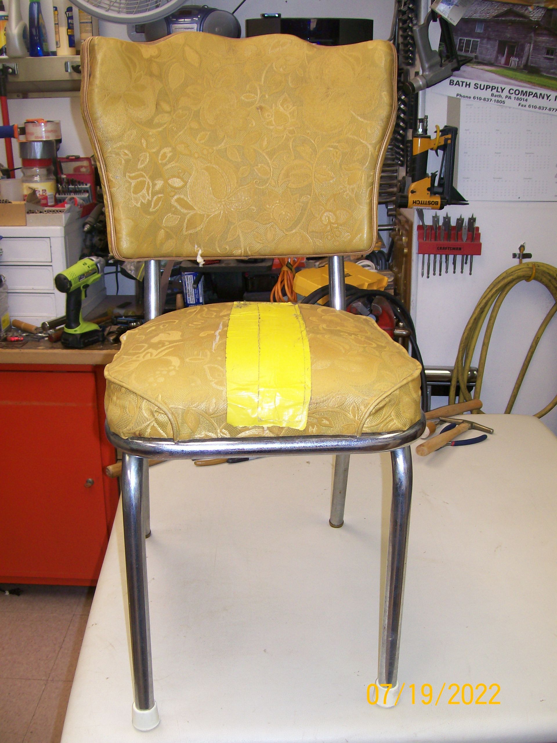 A chair is sitting on a table with a yellow tape on it