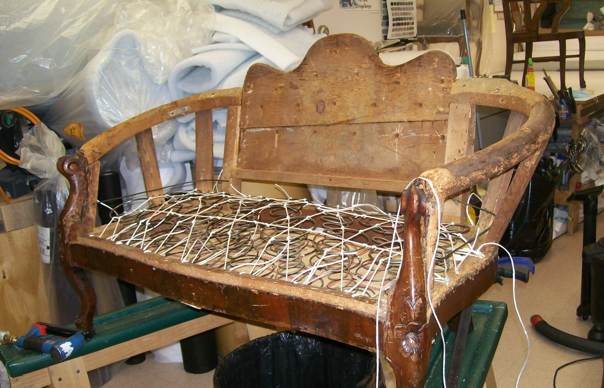 A wooden bench is being rebuilt in a workshop