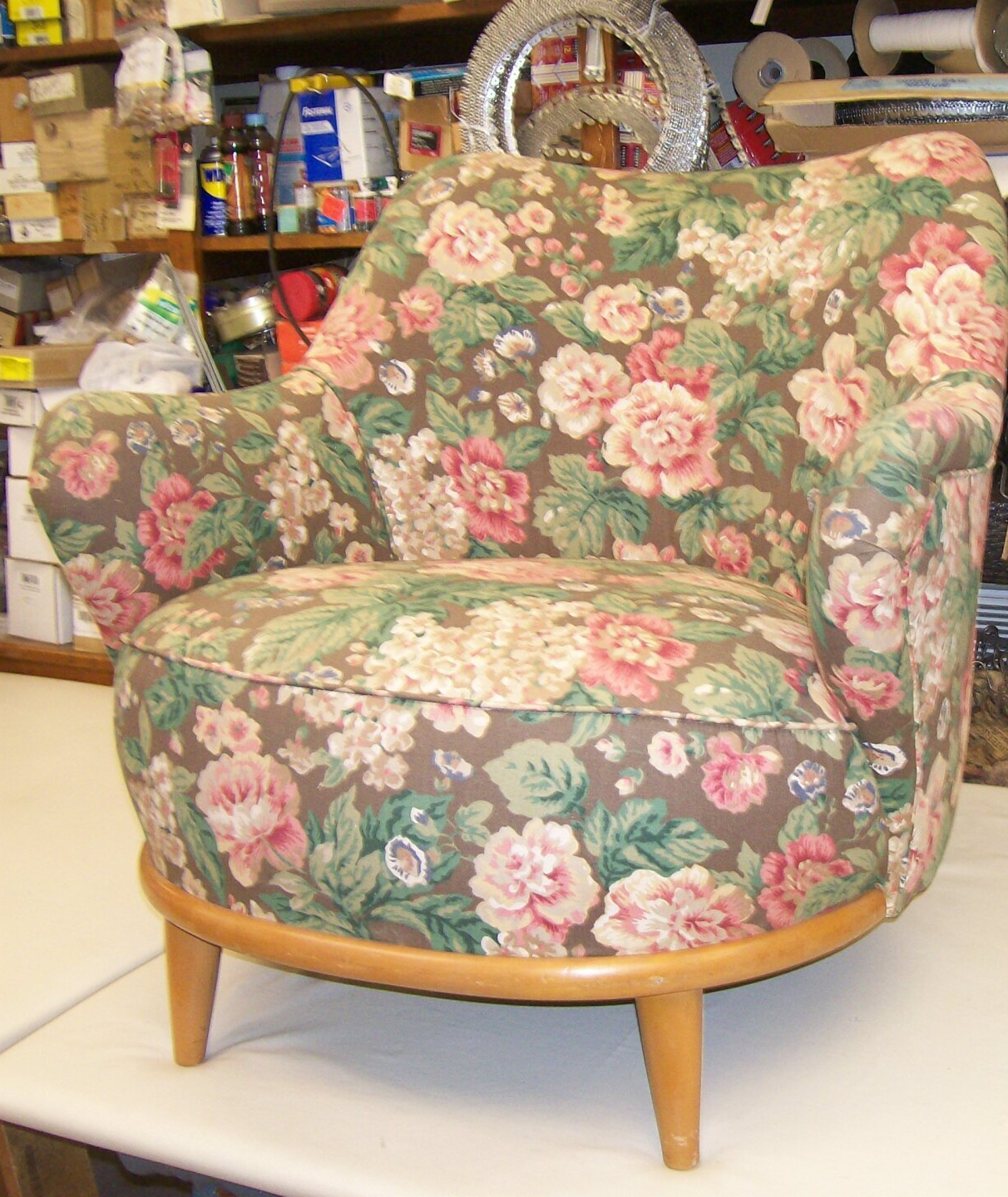 A chair with a floral pattern sits on a table