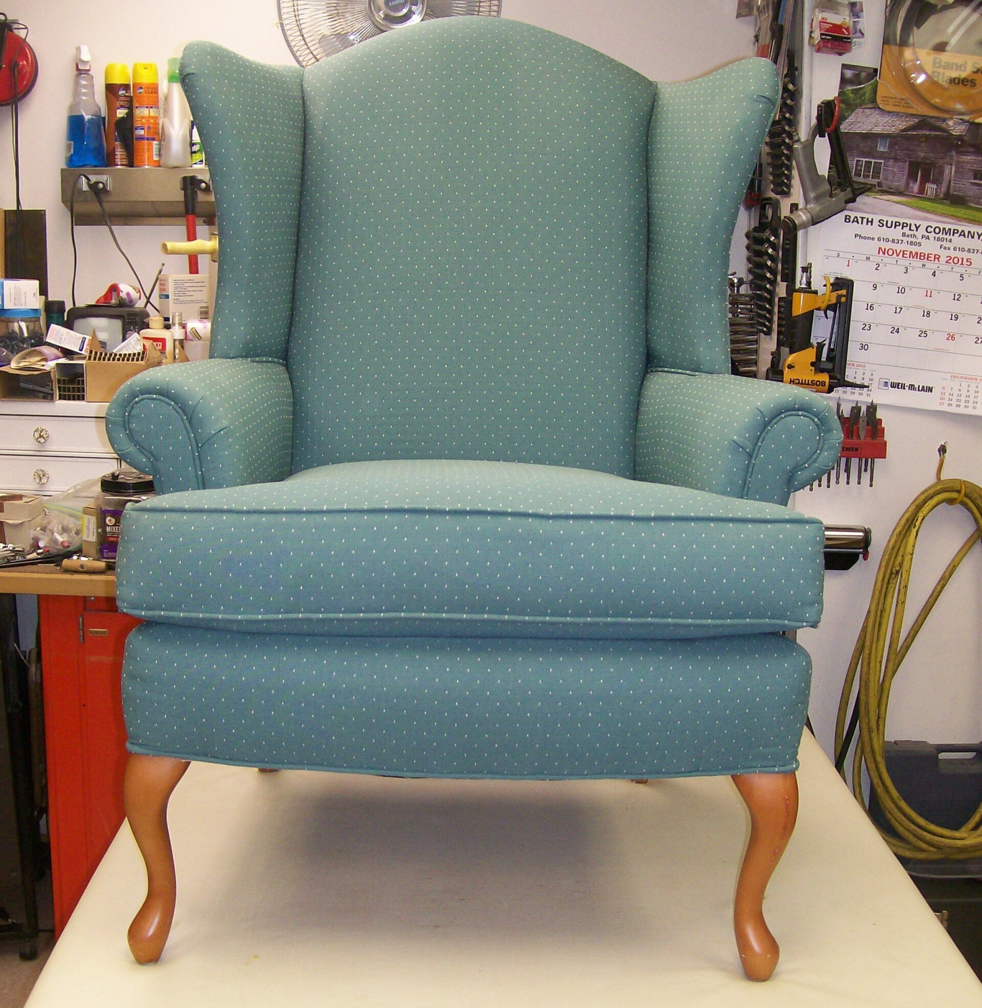 A blue chair with white polka dots sits on a table