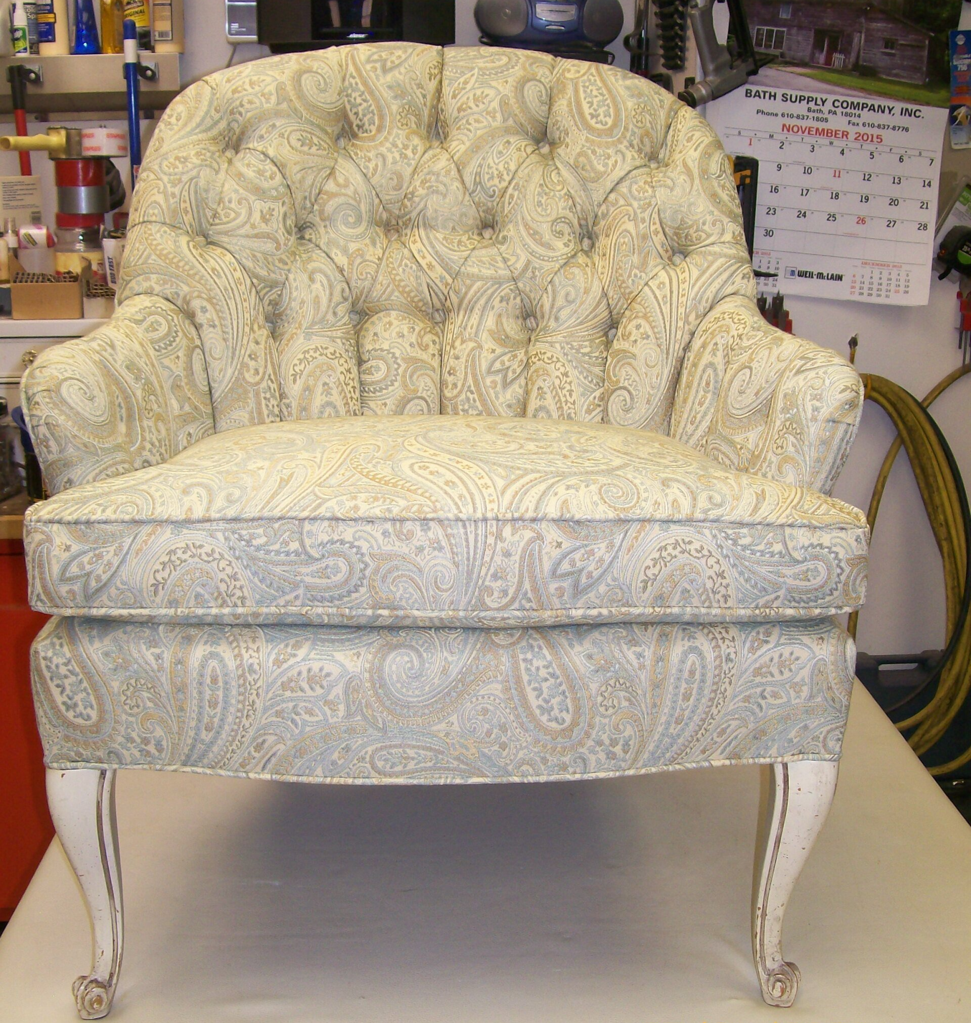 A white chair with a paisley pattern on it