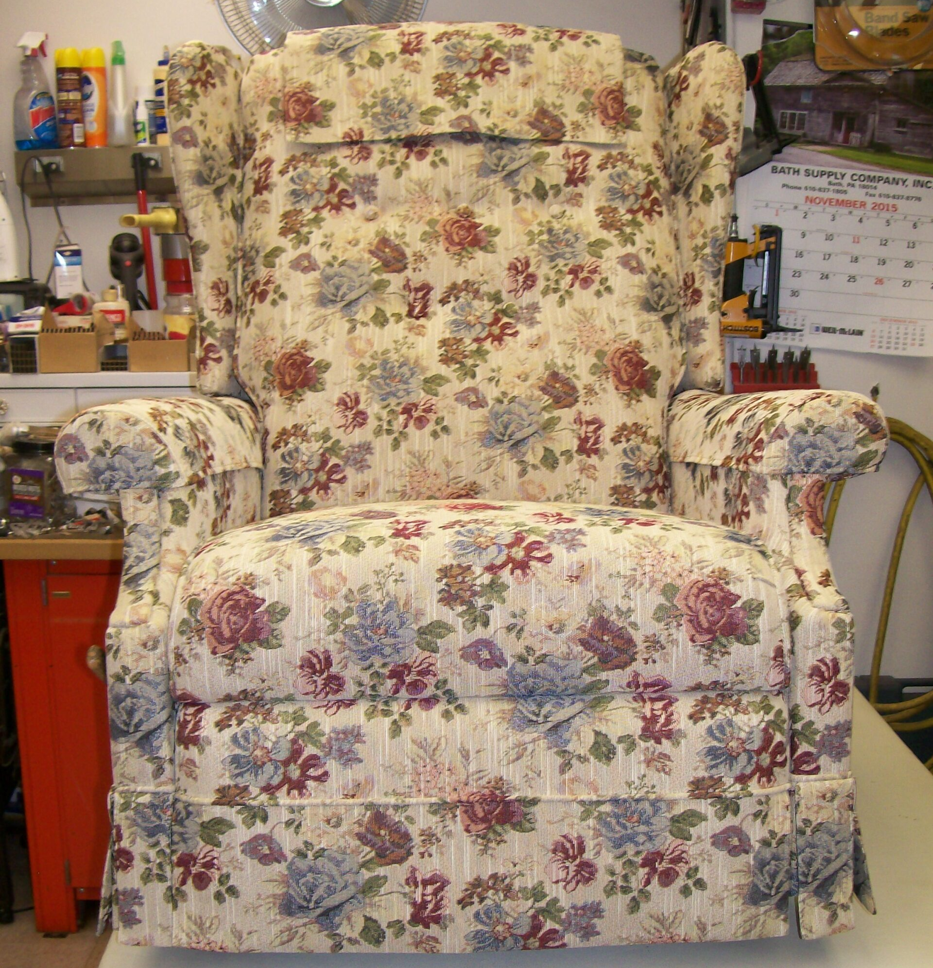 A chair with a floral pattern is sitting on a table