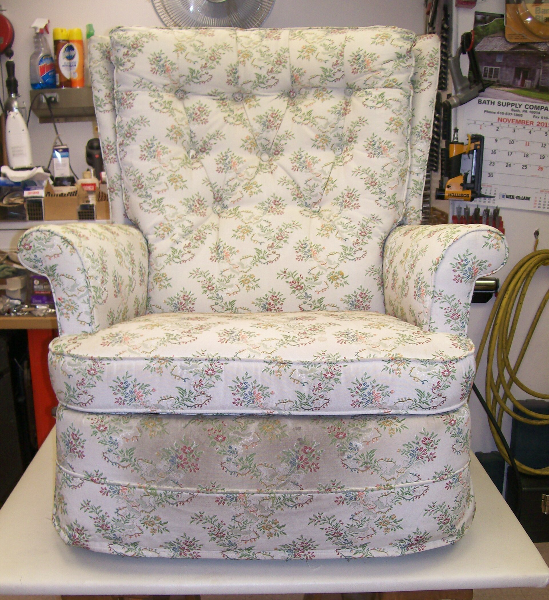 A chair with a floral pattern is sitting on a table