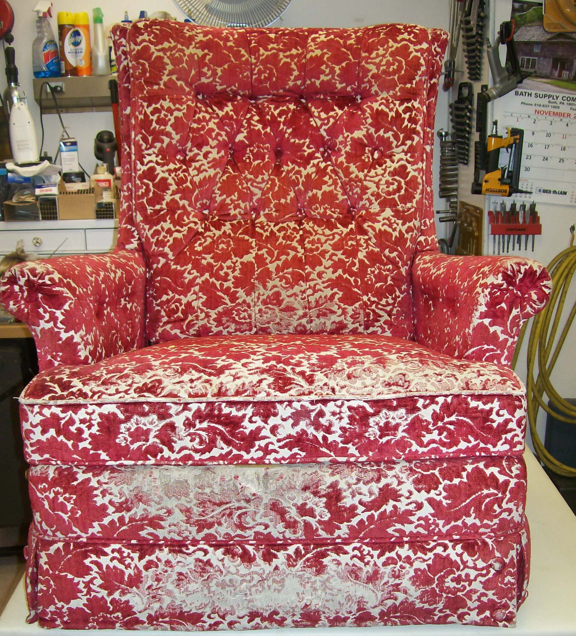 A red and white chair is sitting on a table