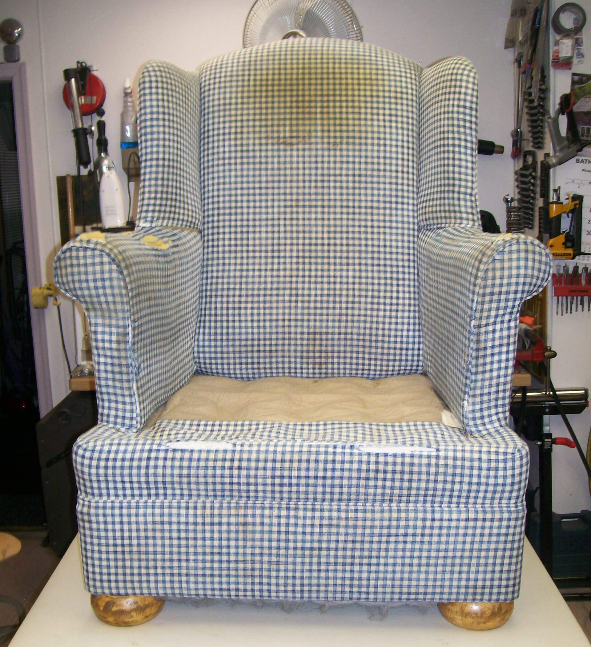 A blue and white plaid chair is sitting on a table