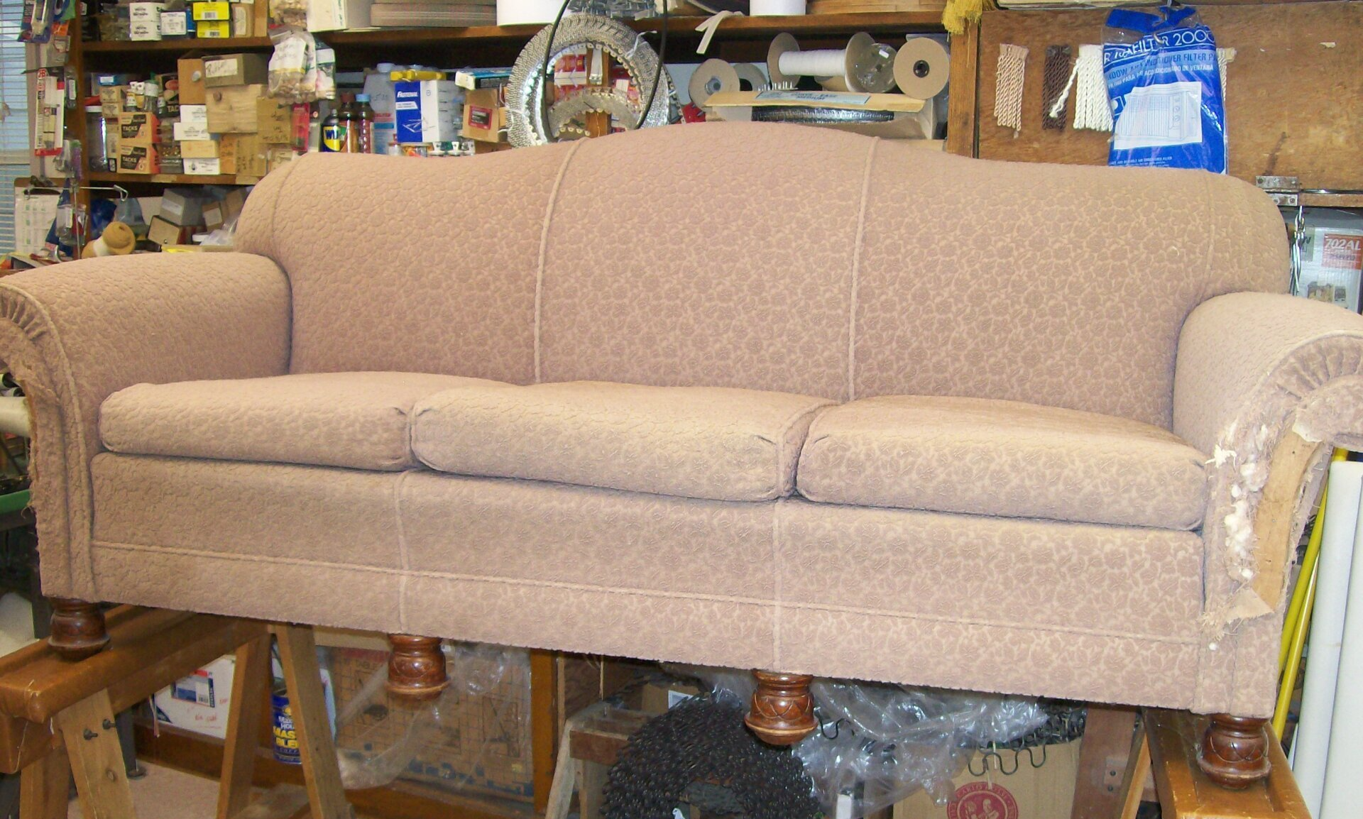 A couch is sitting on a wooden table in a room