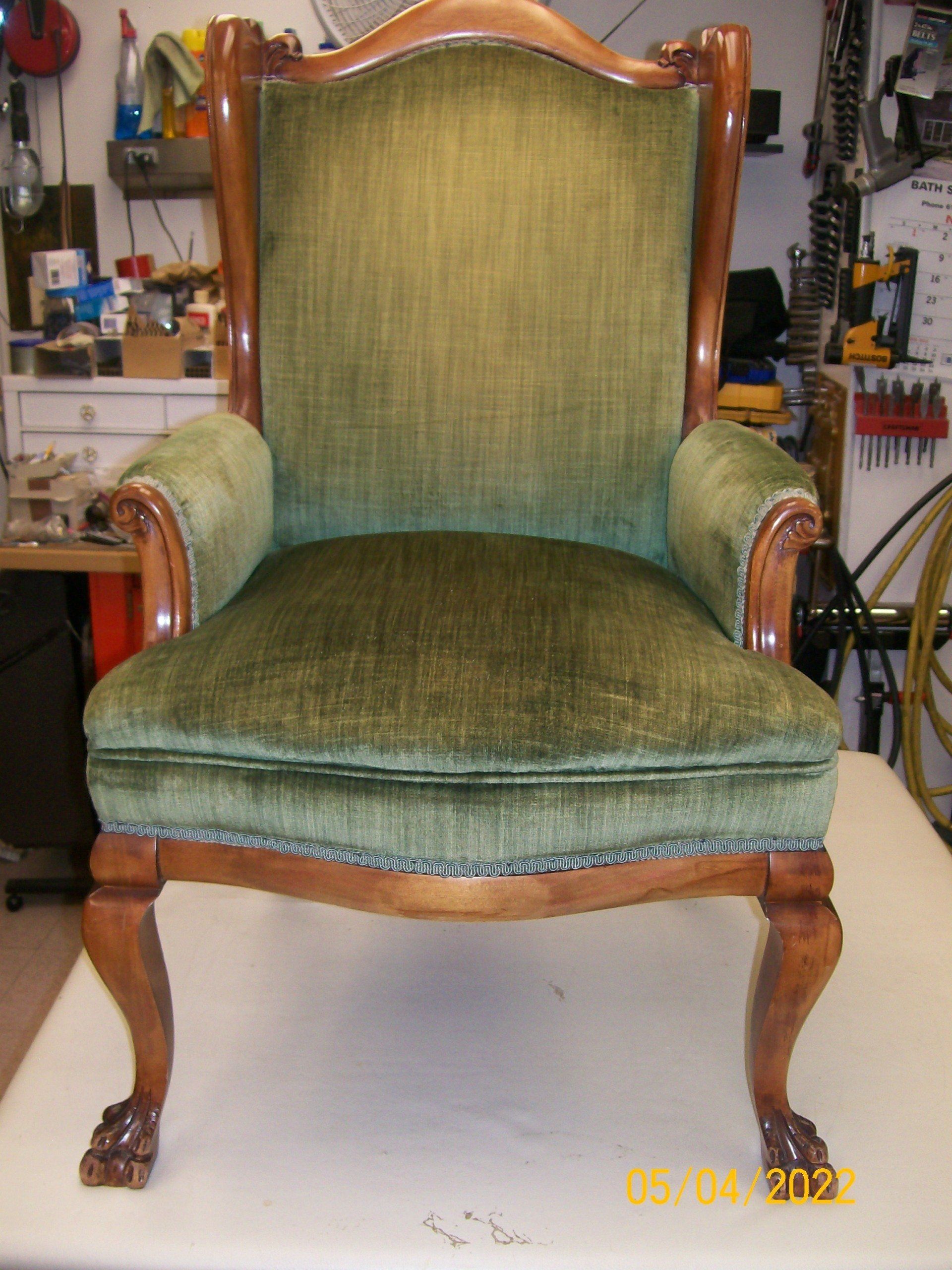 A green chair is sitting on a white table