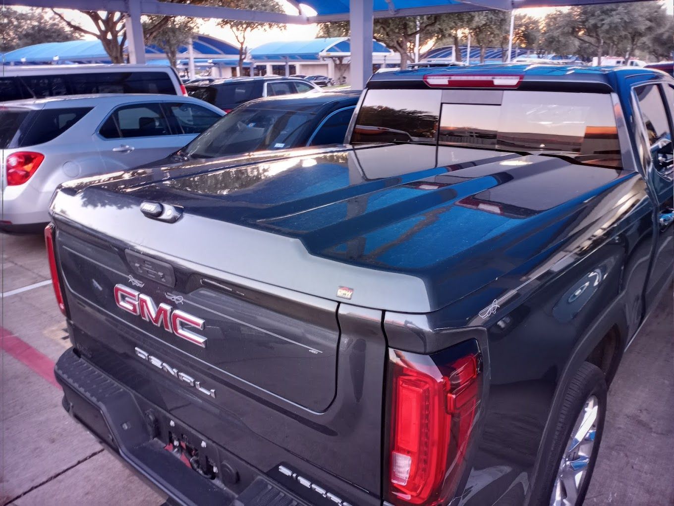 A black gmc truck is parked in a parking lot