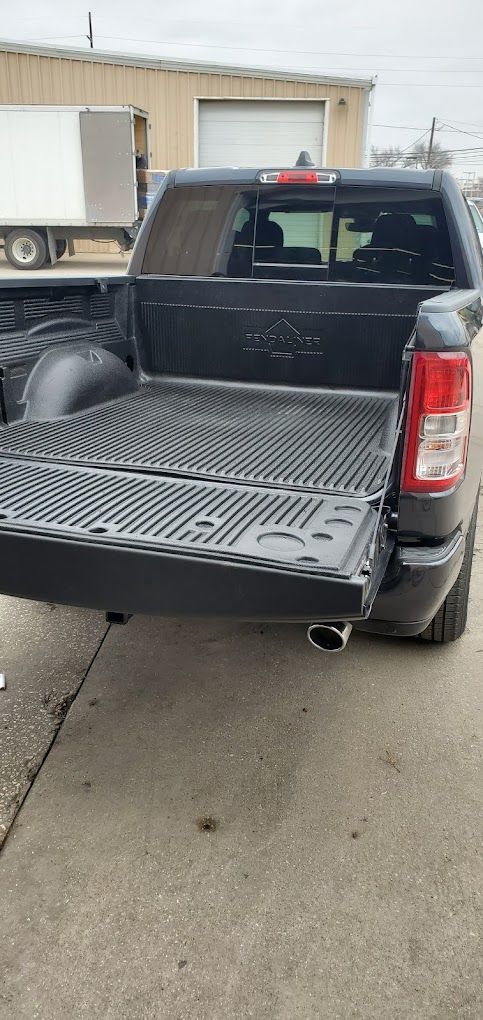 A black pickup truck is parked on the side of the road.