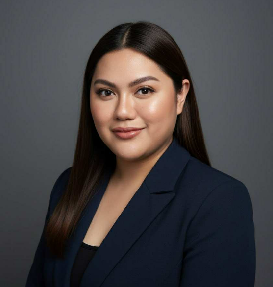 A woman with long hair is wearing a black tank top and smiling.