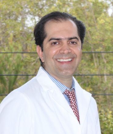 Smiling man, dentist Dr Youselfi