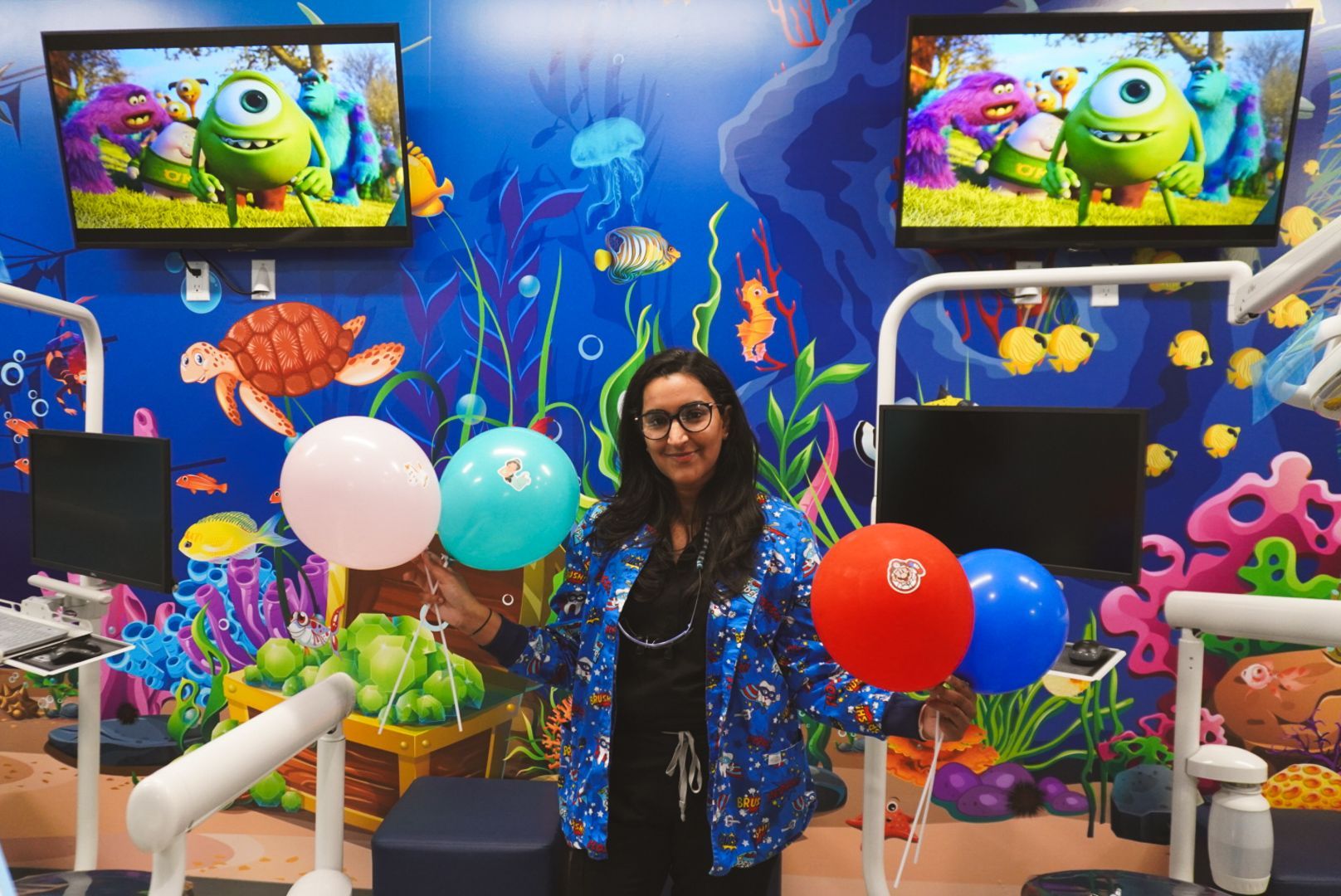 Woman holding balloons in dental office
