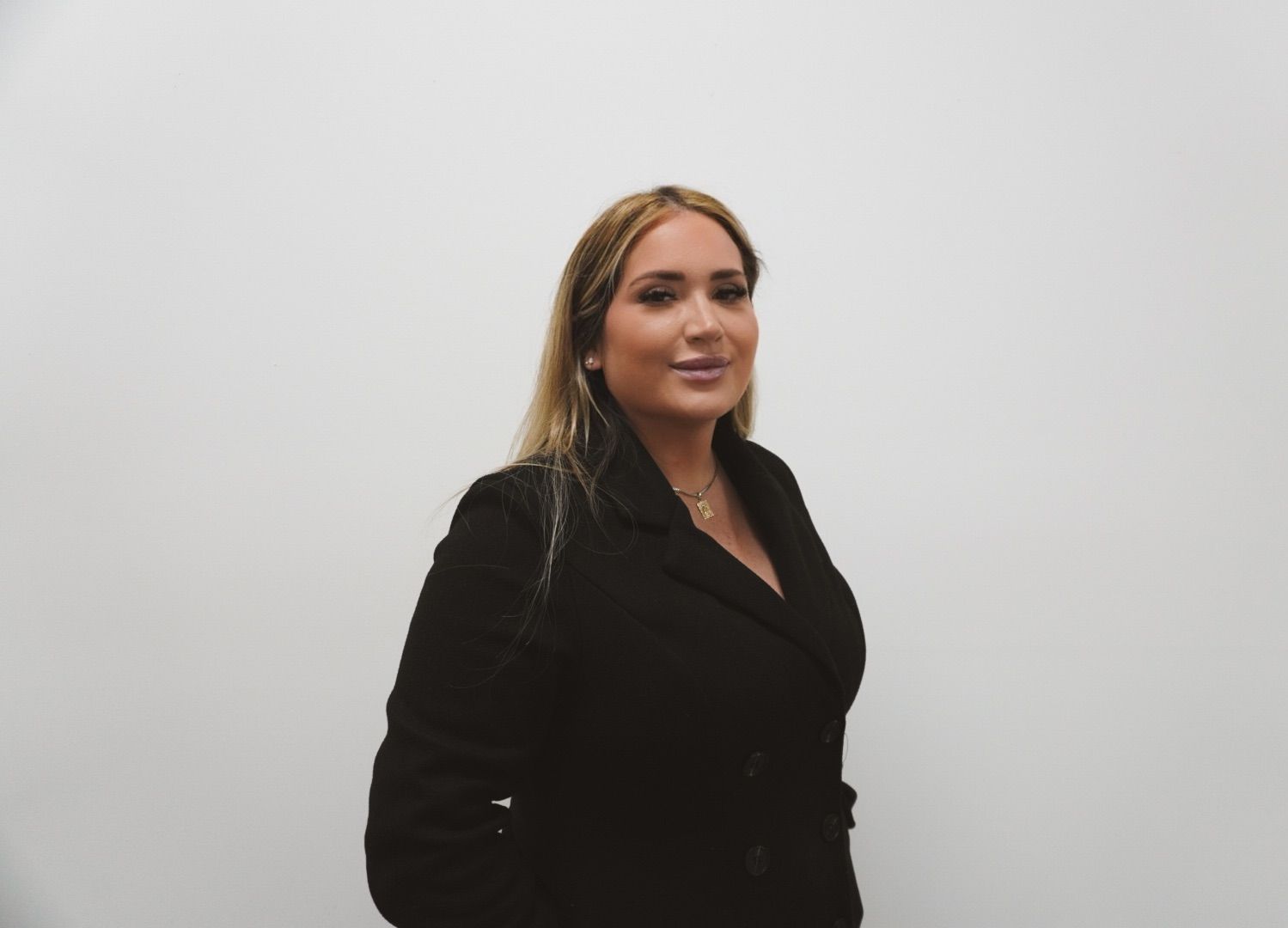 Blonde woman in black suit