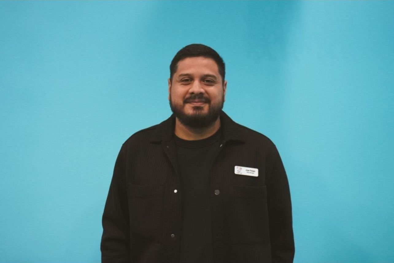 Man with dark hair and black attire