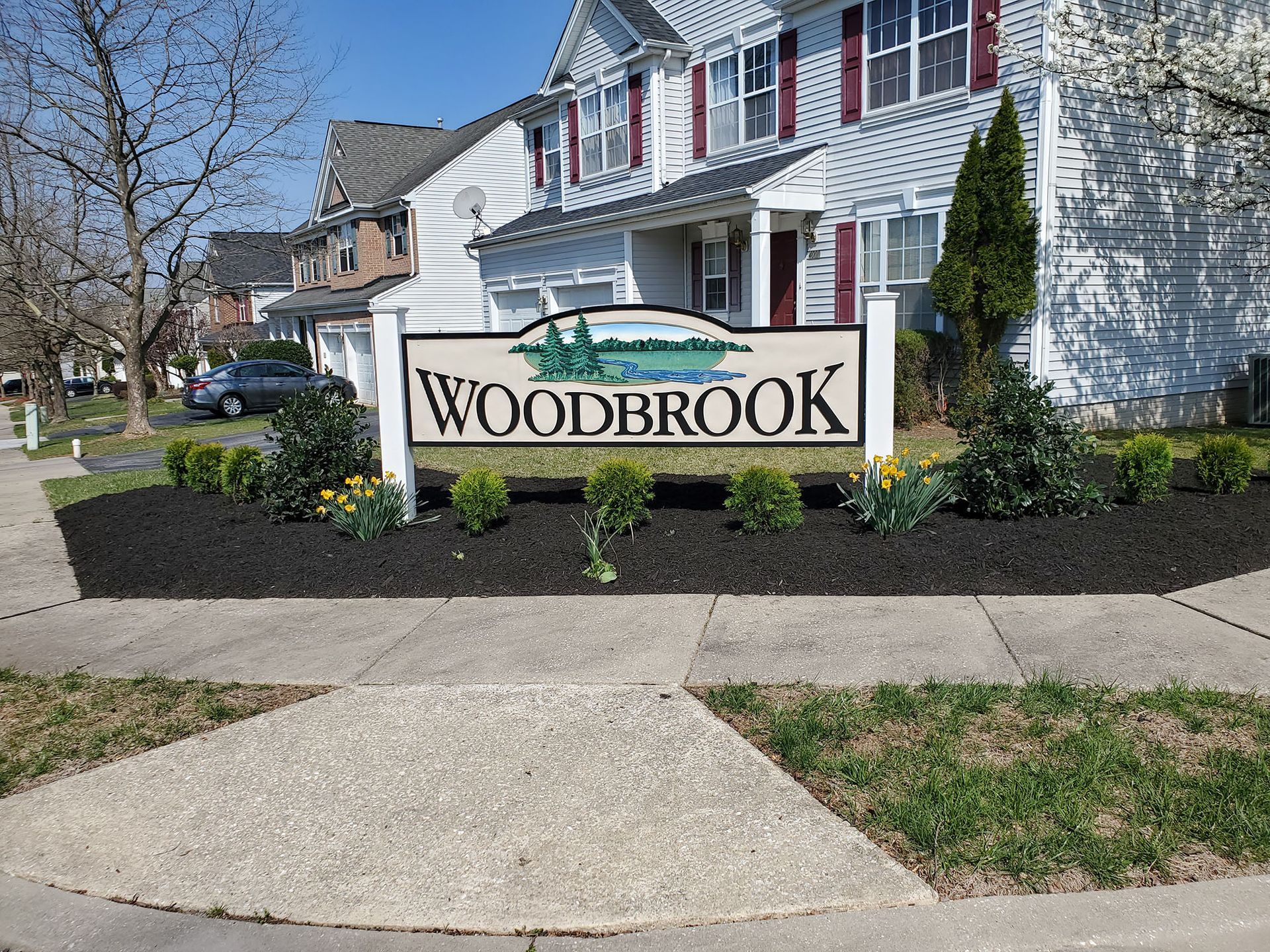 Woodbrook sign in front of a lawn