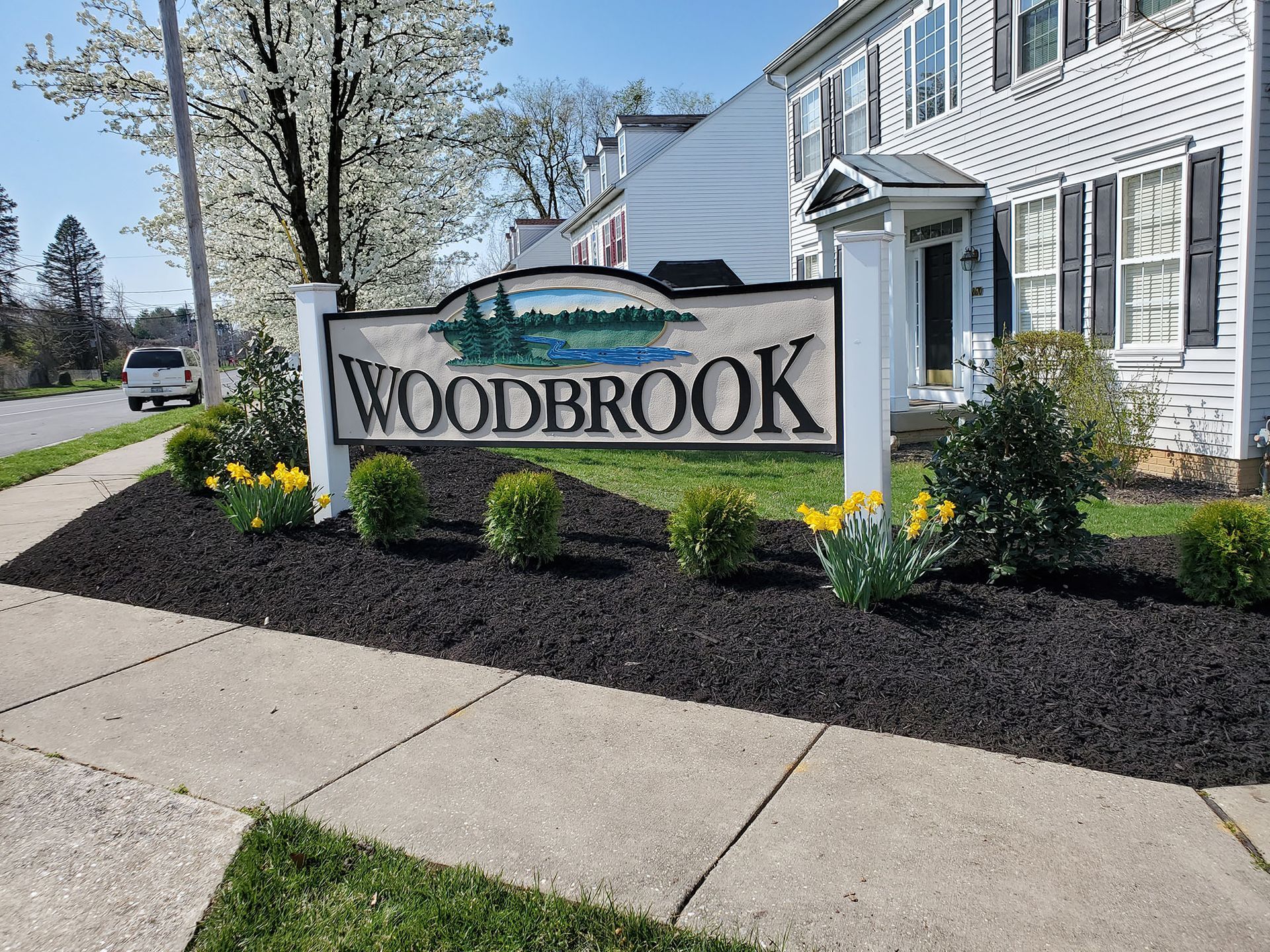 Woodbrook sign in front of a lawn