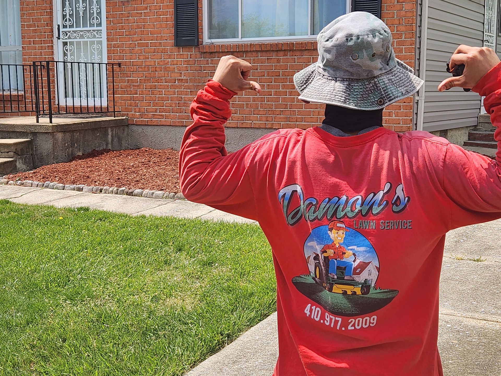 Lawn service staff pointing at his own shirt