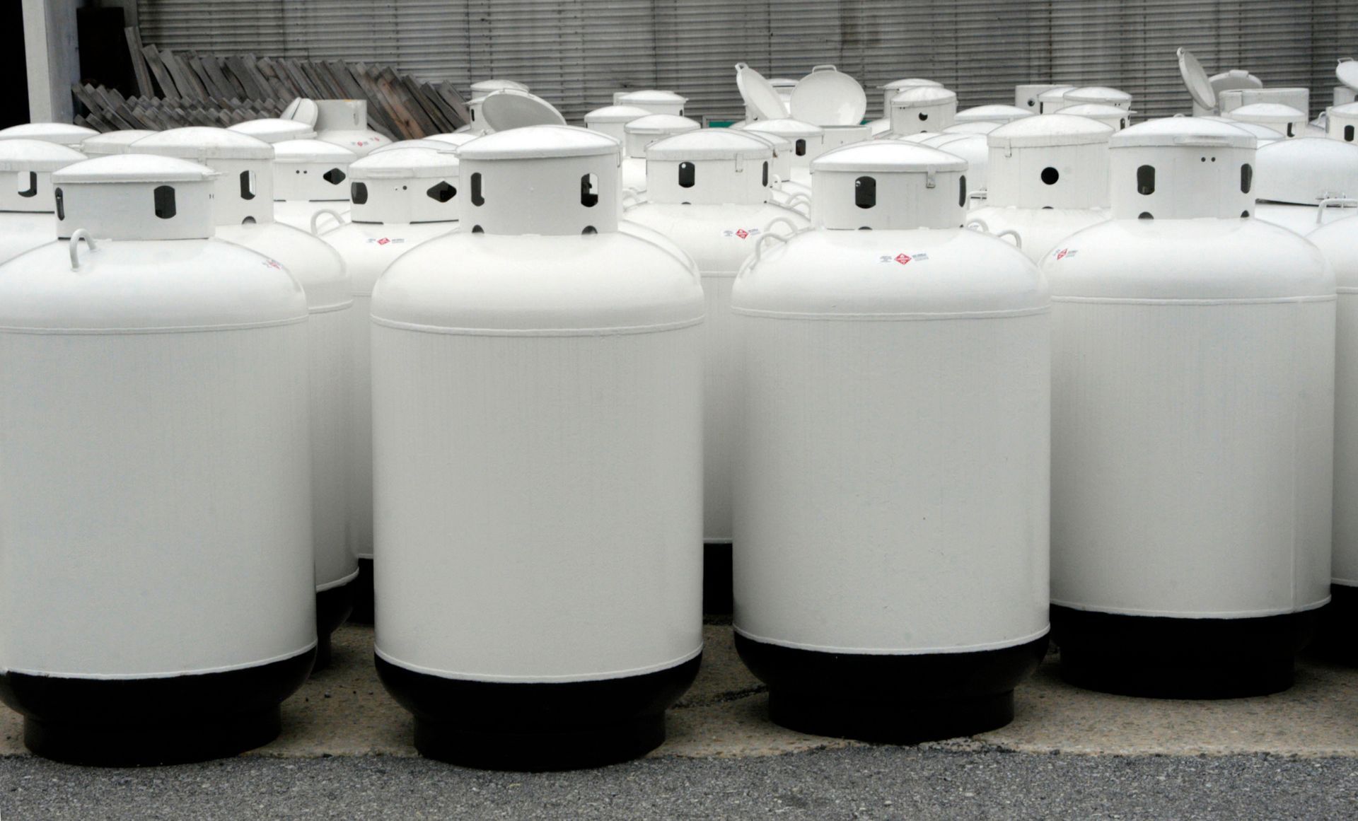 White propane tanks in an outdoor setting.