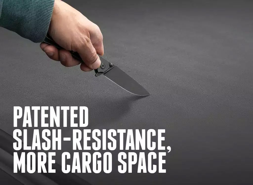 Hand holding a knife over dark fabric, with text: Patented slash-resistance, more cargo space.