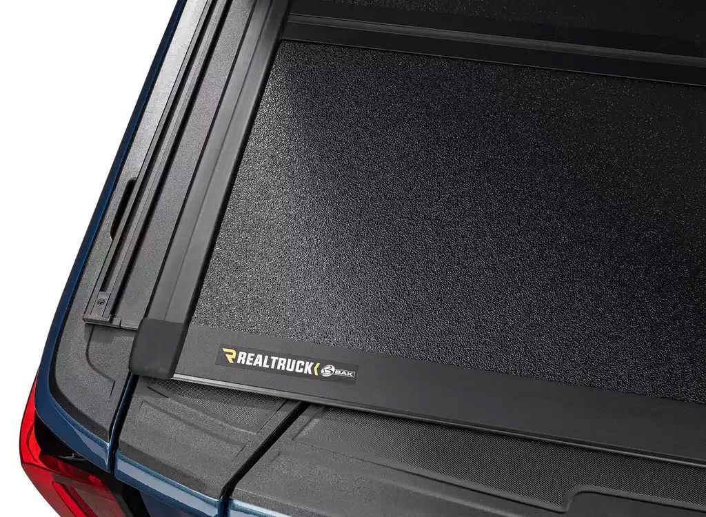 Rear window of a car with a black textured cover and wiper, labeled RAPTOR.