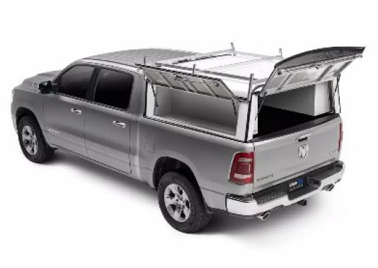 Gray pickup truck with a metal rack and open camper shell cargo cover