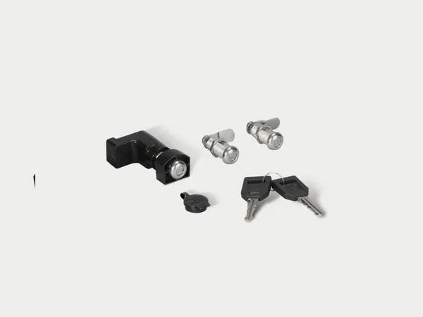 Small black and silver hardware parts and screws arranged on a white background