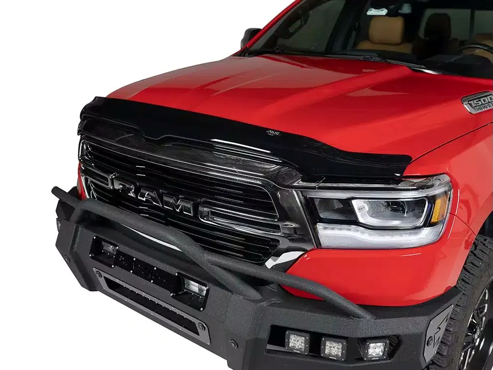 Red pickup truck front end with black grille and bumper trim on a white background