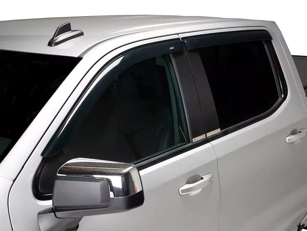 White pickup truck with tinted side windows and chrome side mirror, close-up view