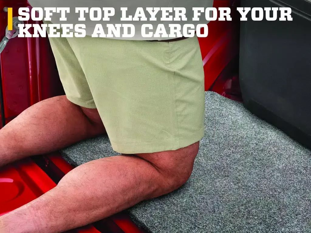 Person kneeling on a gray car mat in red cargo area, with text: Soft top layer for your knees and cargo