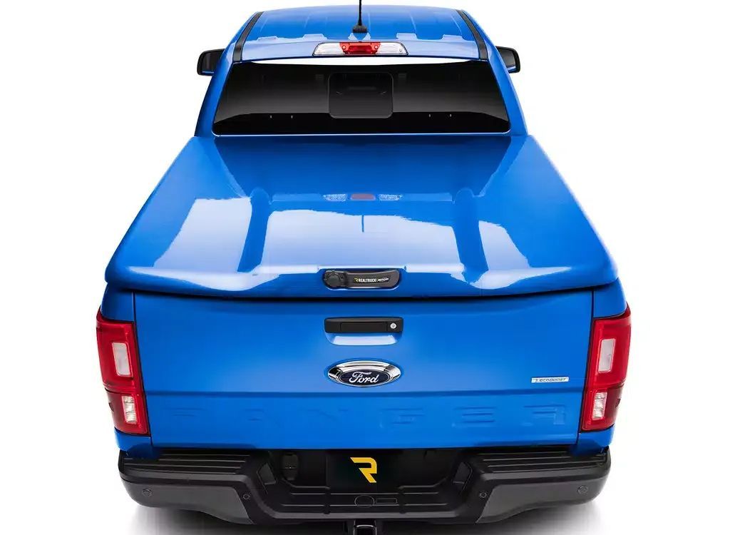 Blue pickup truck viewed from the rear on a white background