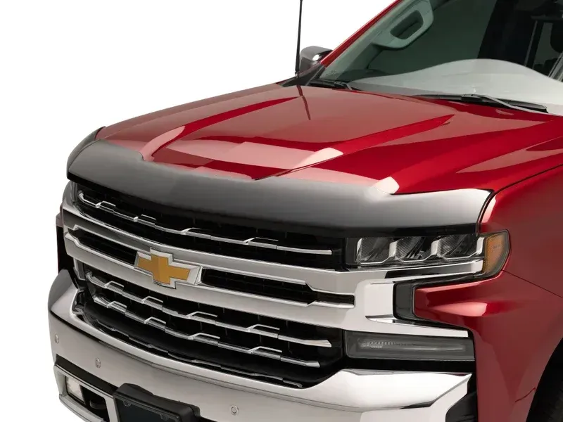 Close-up of a red Chevrolet truck front grille and hood