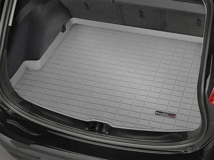 Car trunk cargo area with a gray custom-fit floor mat installed