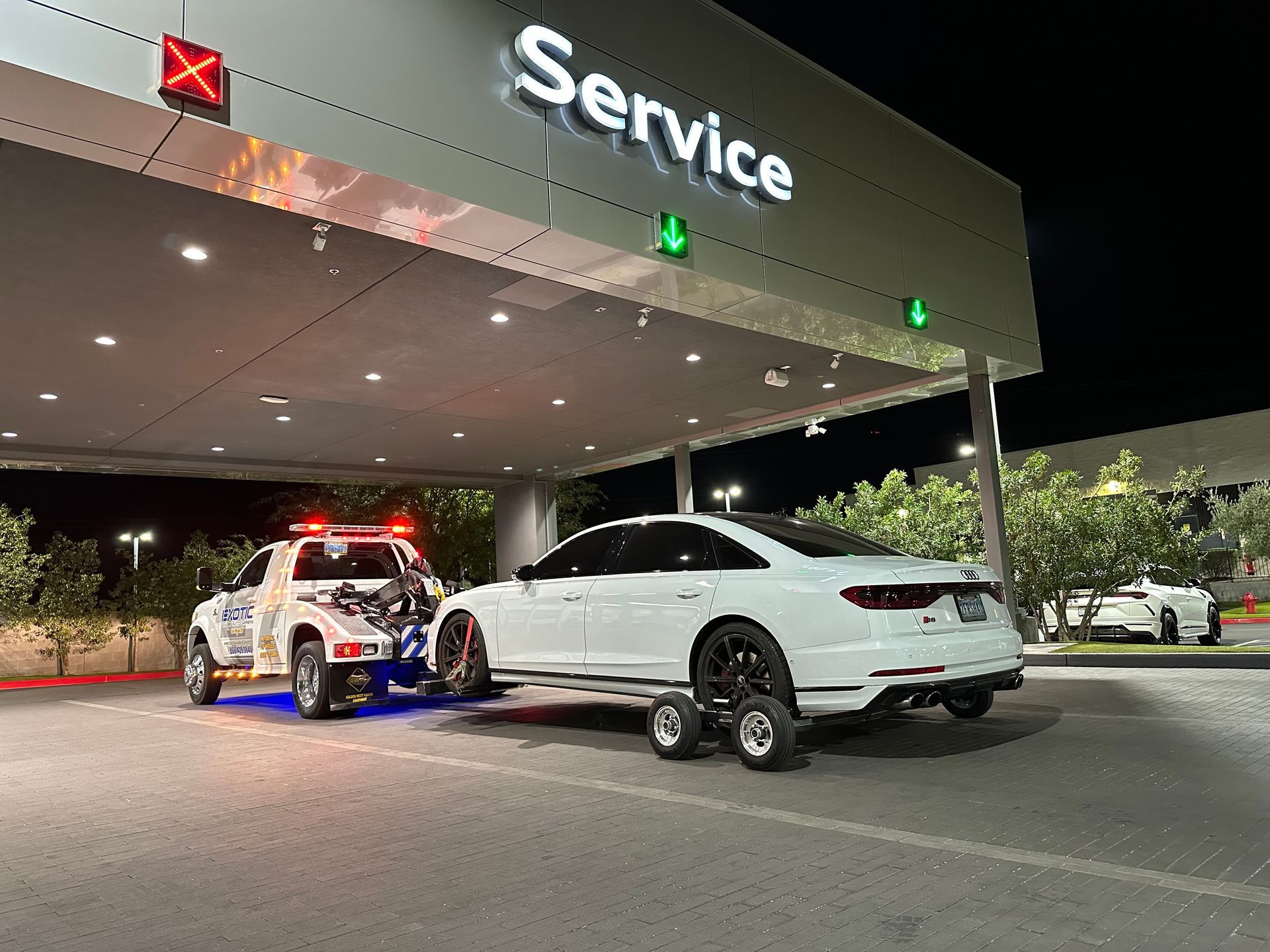 White car being towed by a truck