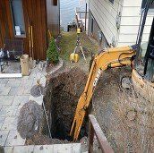 Backhoe digging a hole