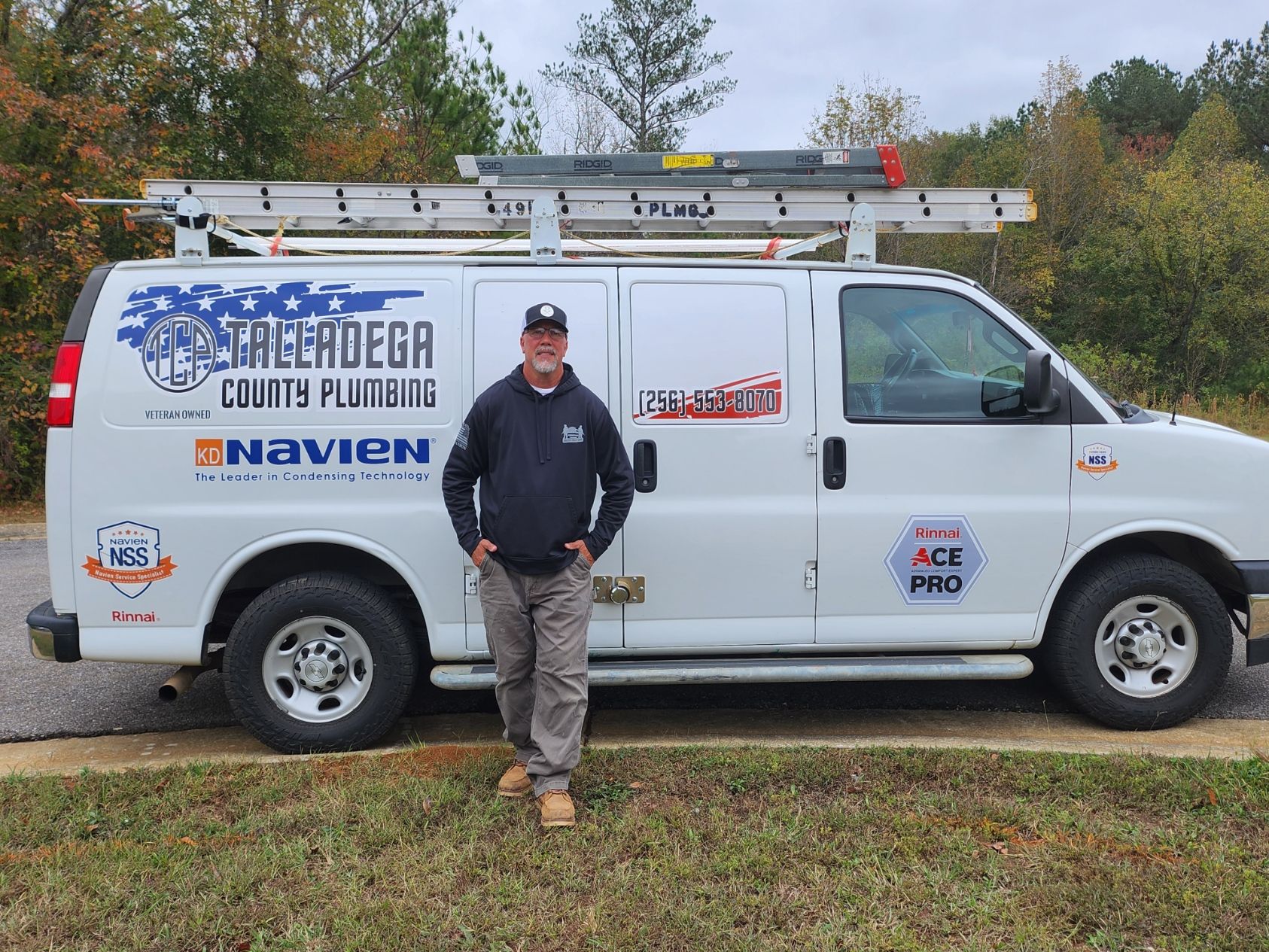 Man in front of a plumbing van, 