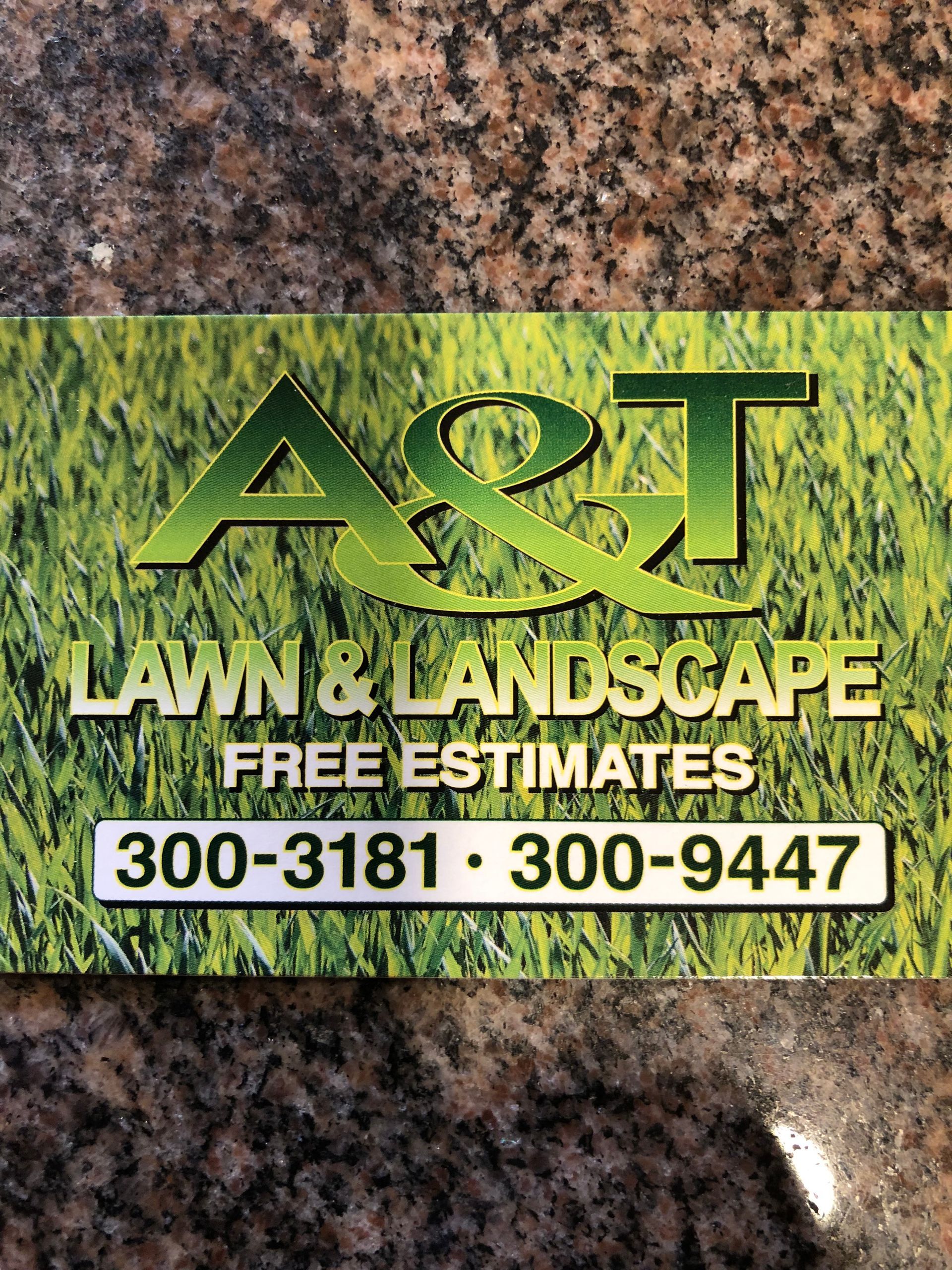 A and T Lawn and Landscape Logo