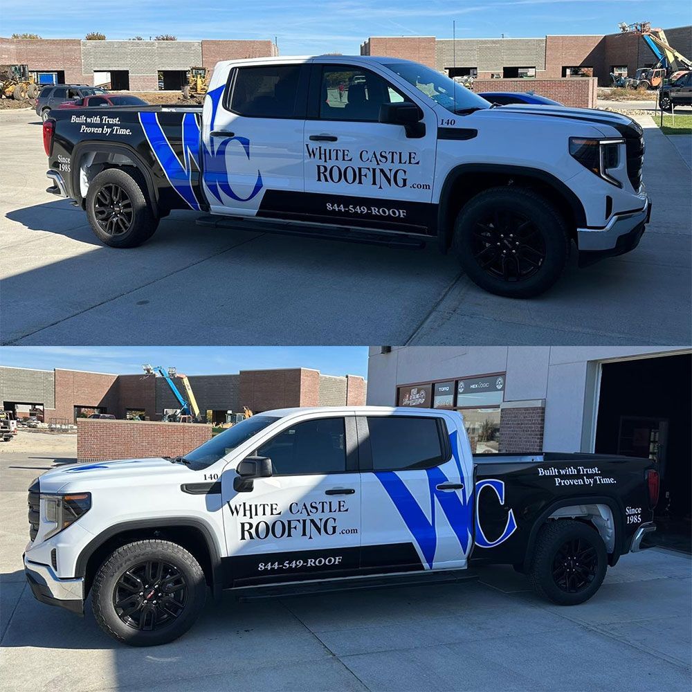 A white castle roofing truck is parked in front of a building