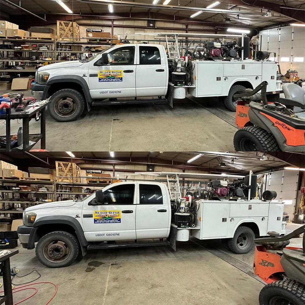 A white truck with a trailer attached to it is parked in a garage.