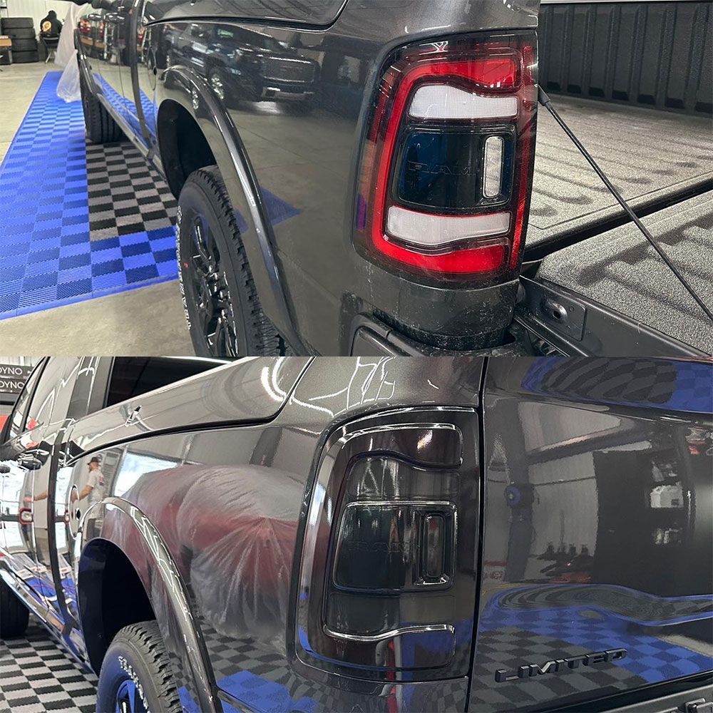 A ram truck is sitting on a checkered floor in a garage.