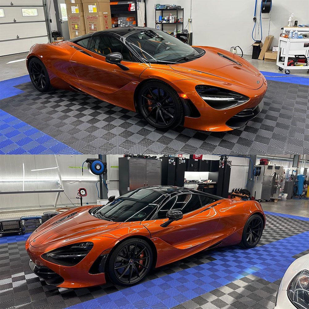 A mclaren 720s is sitting on a checkered floor in a garage.