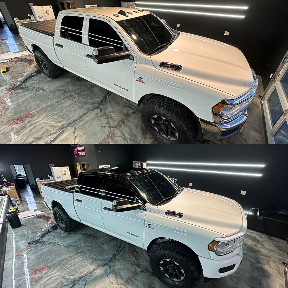A white truck is sitting on a marble floor in a garage.