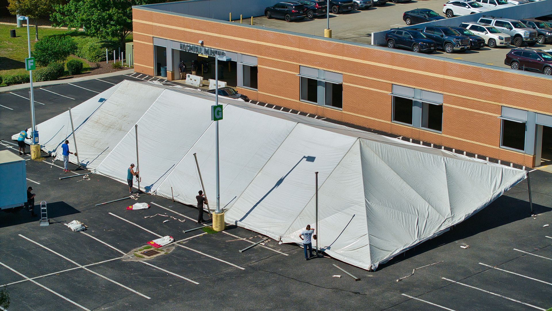 Large white tent set up in a parking lot