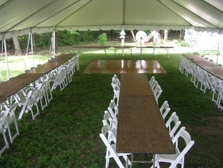 Tables and chairs under a tent with a dance floor