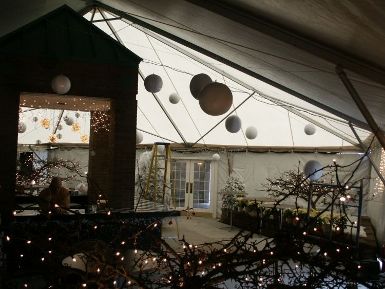 The inside of a tent with lanterns hanging from the ceiling
