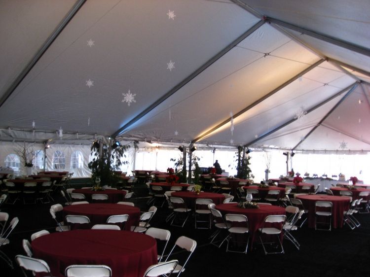 Tables and chairs under a tent with snowflakes on the ceiling