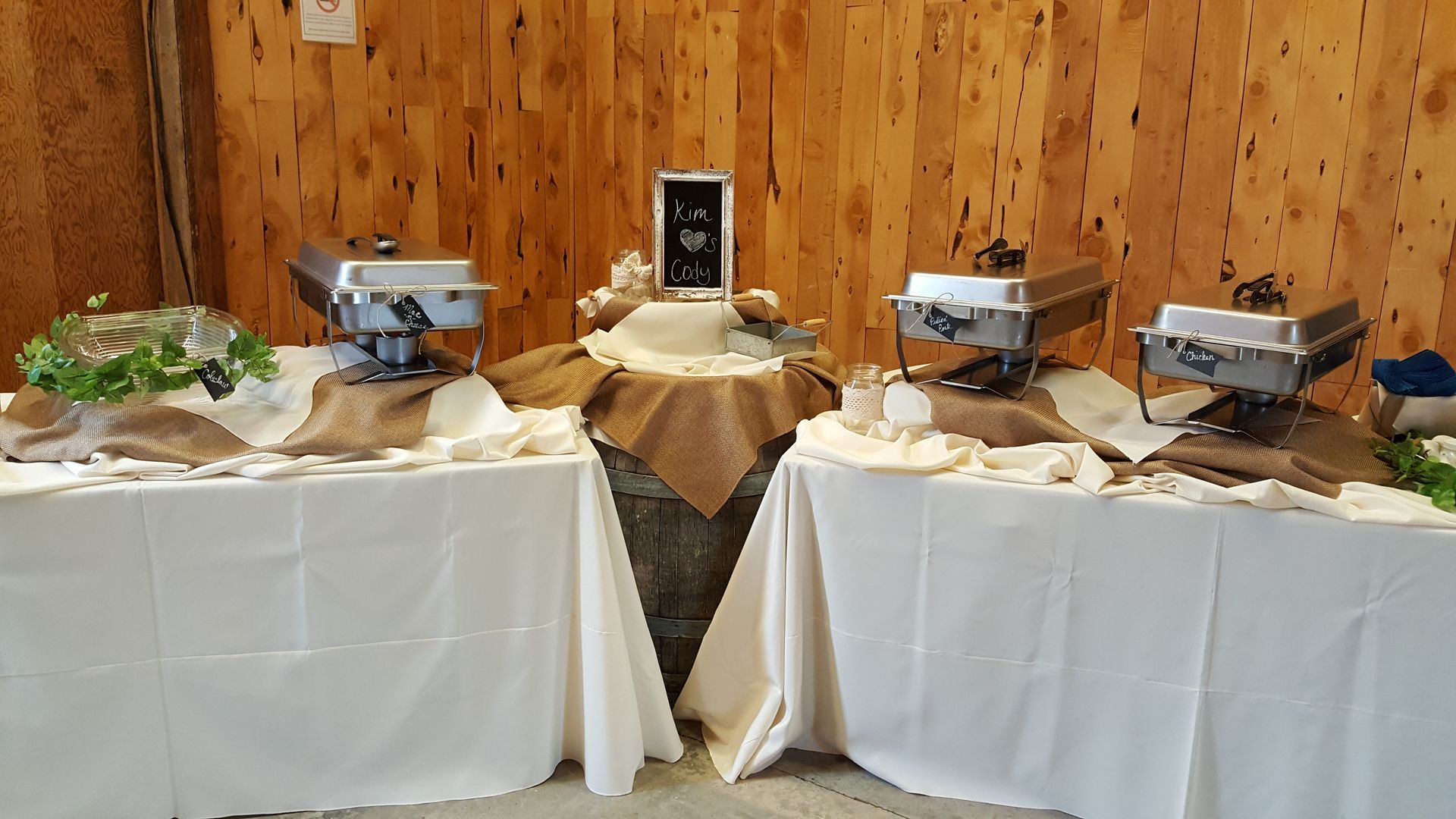A buffet table with a wooden wall in the background.