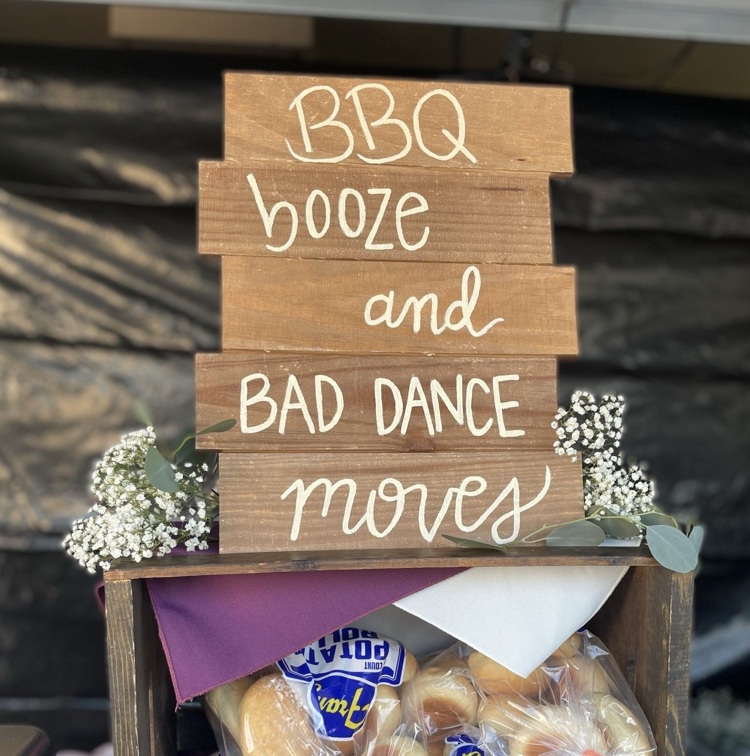 A wooden sign that says bbq booze and bad dance moves