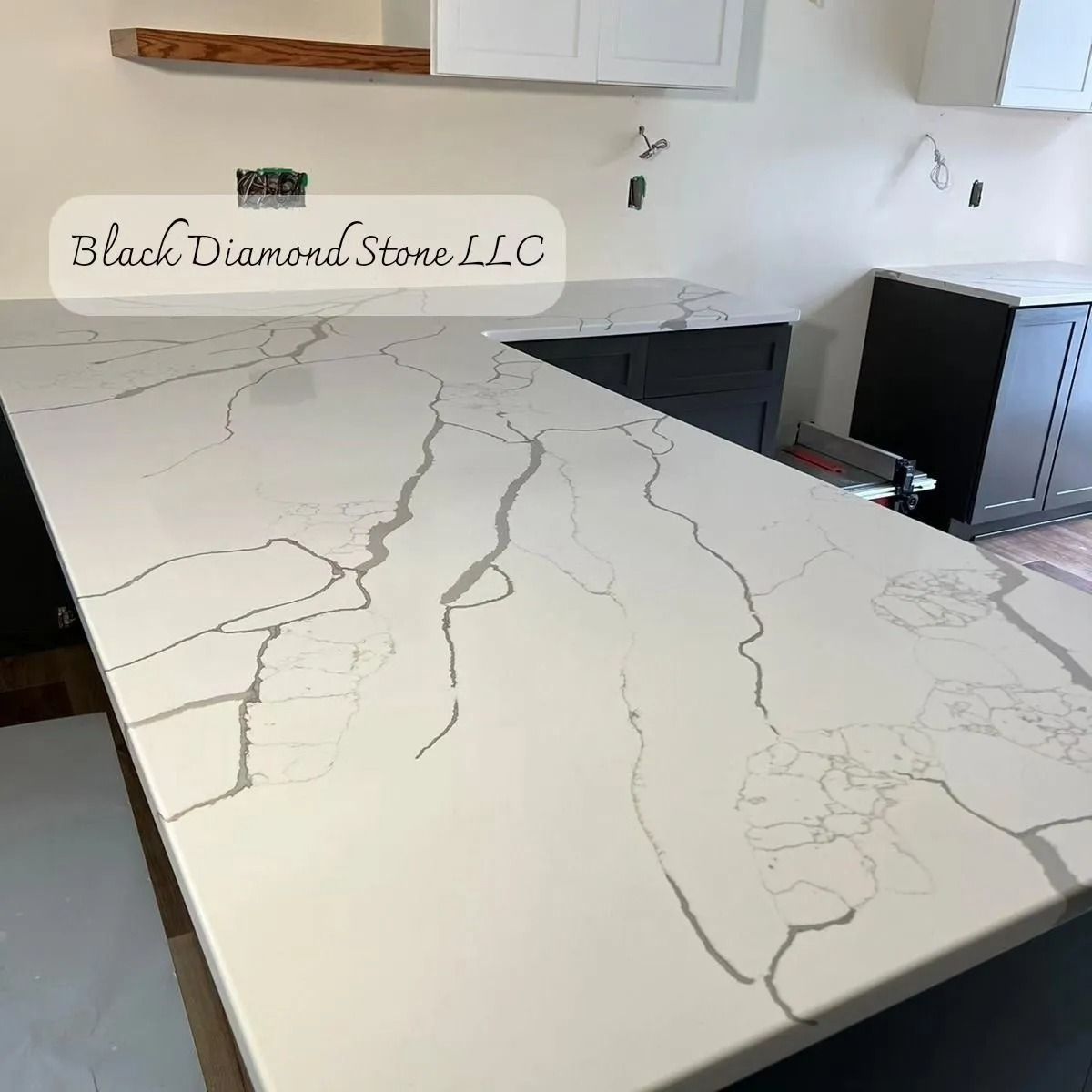 White countertop with grey veining in a kitchen, installed by Black Diamond Stone LLC.