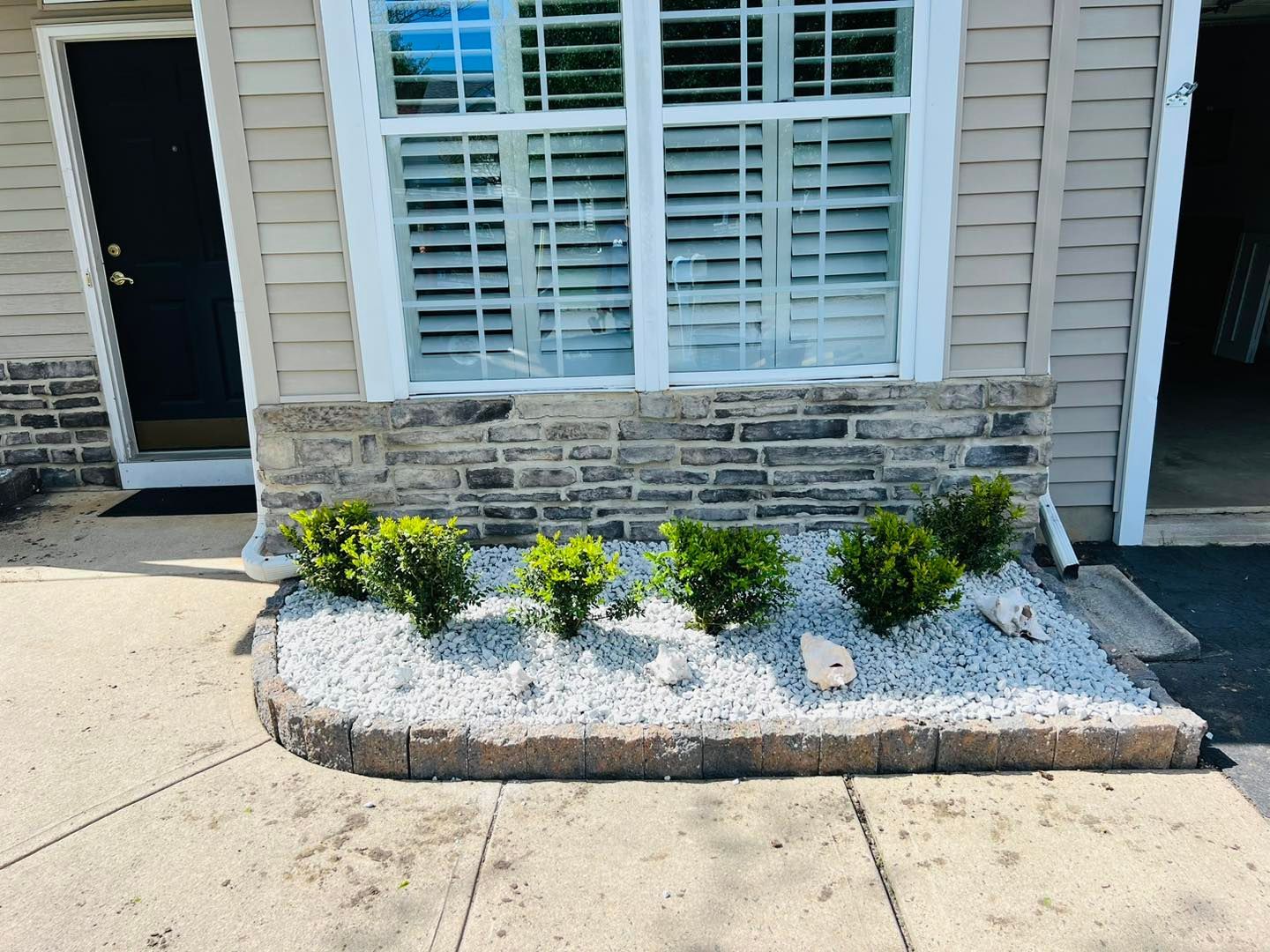 A house with a window and a planter in front of it