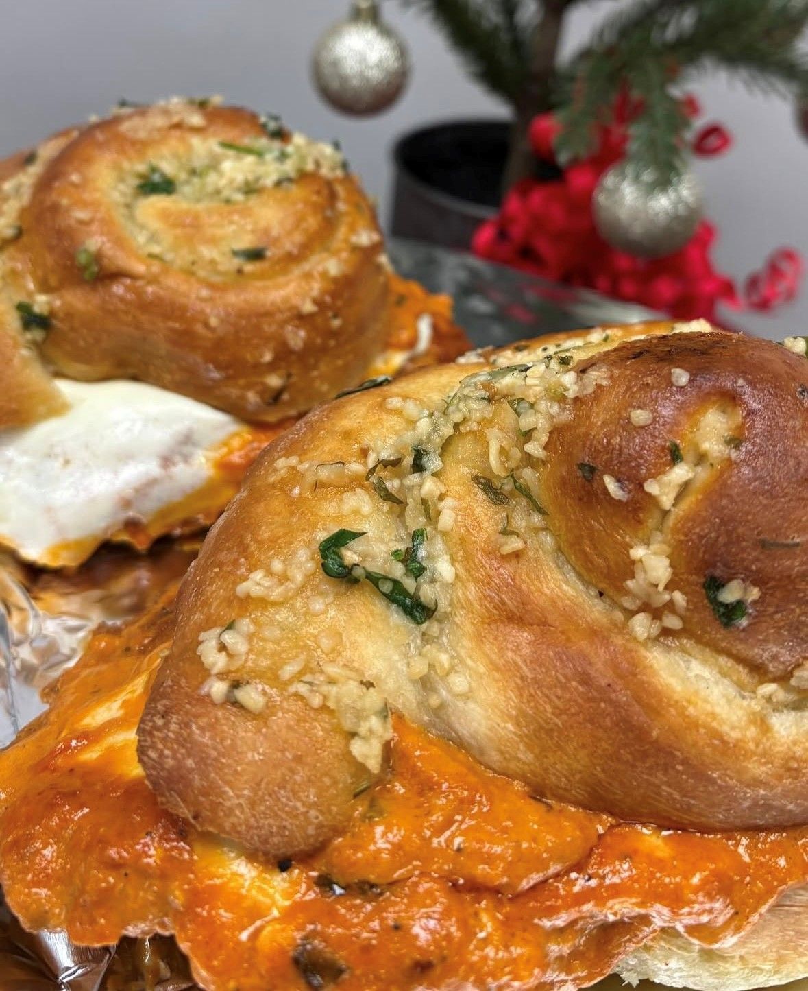 Two garlic bread sandwiches with red sauce and what appears to be cheese.
